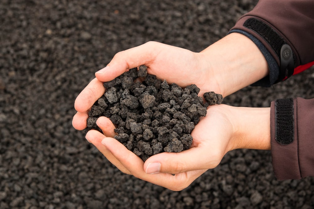 a hand full of small lava rocks