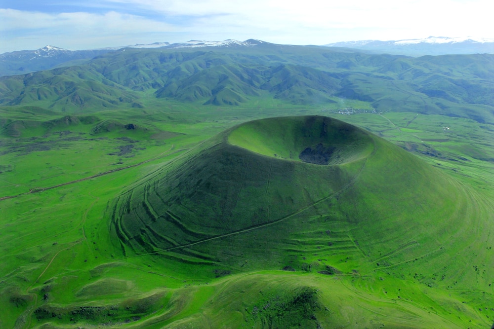 Volcano field with green grass