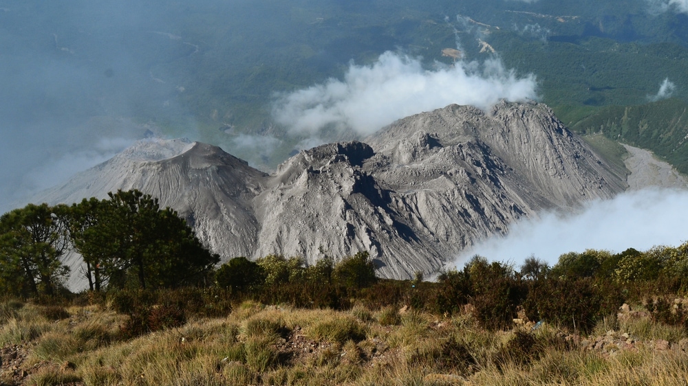 Calm volcano surrounded by clouds