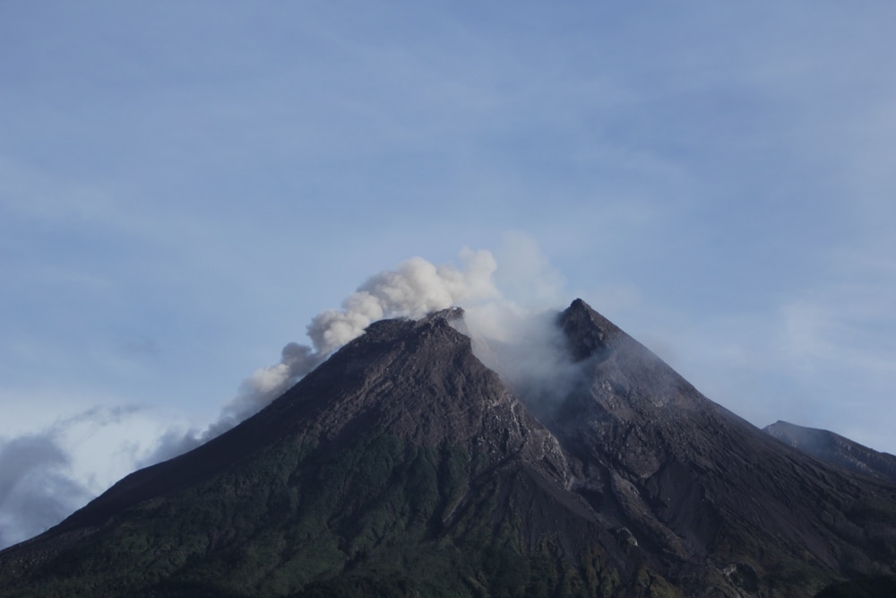 Volcano releasing smoke on its crater