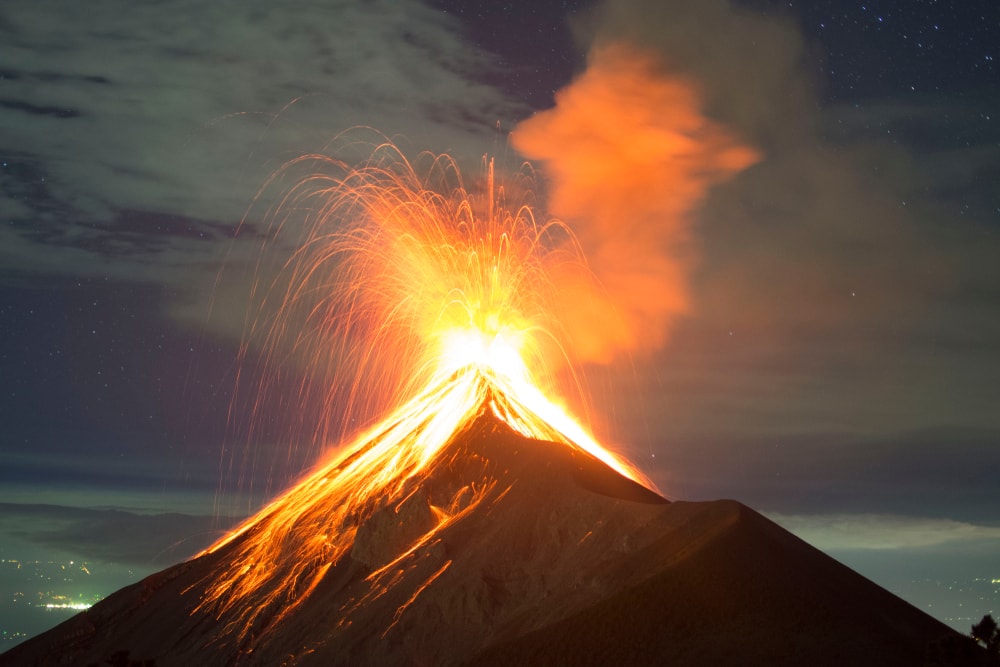 Volcano erupting at night