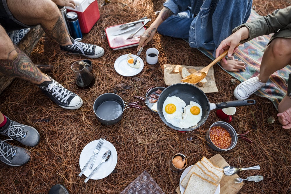 Foods on the ground with people surrounding it