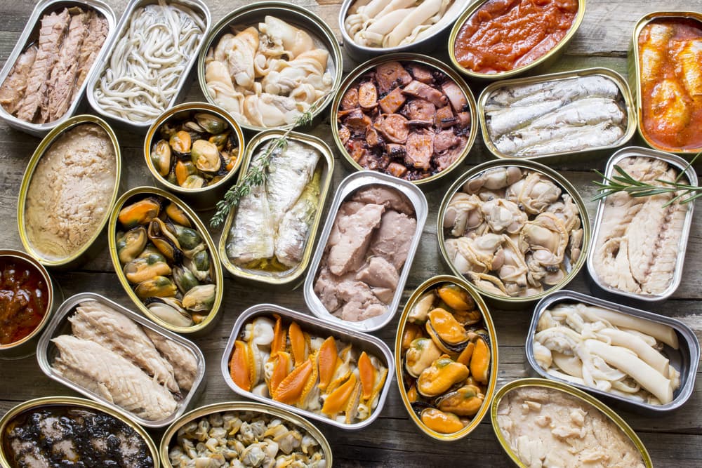 Lots of canned fish laying on a table