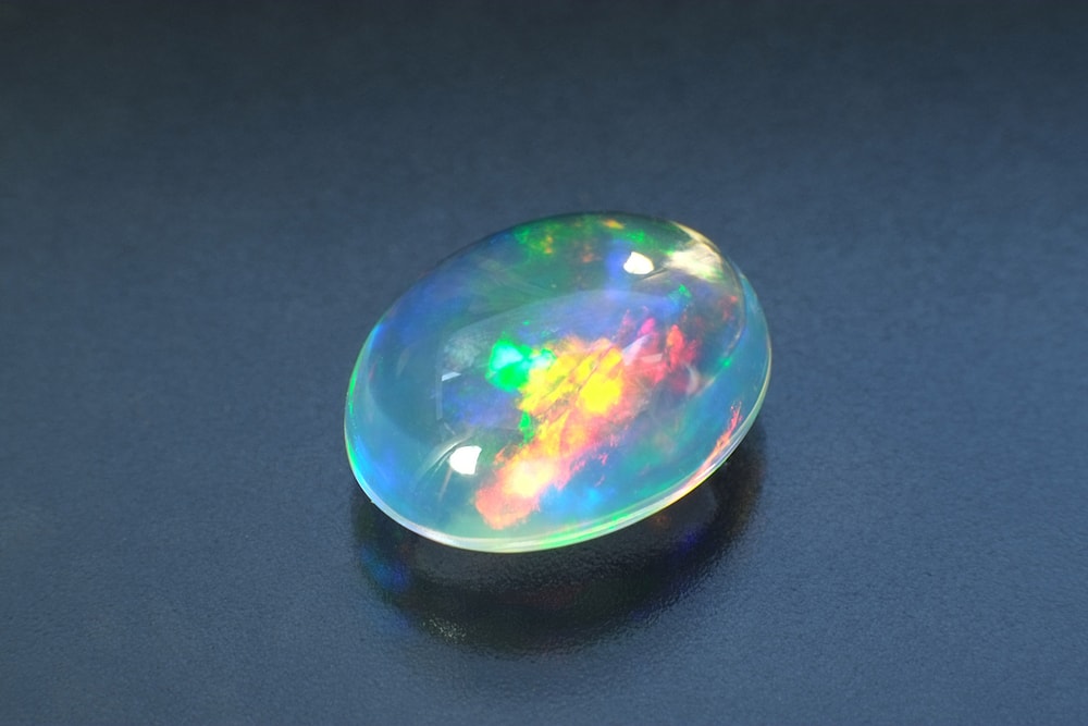 Opal laying on a blue table