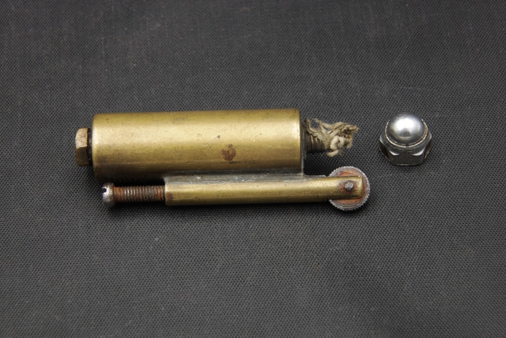 Trench Rope Lighter laying on a rough black cloth