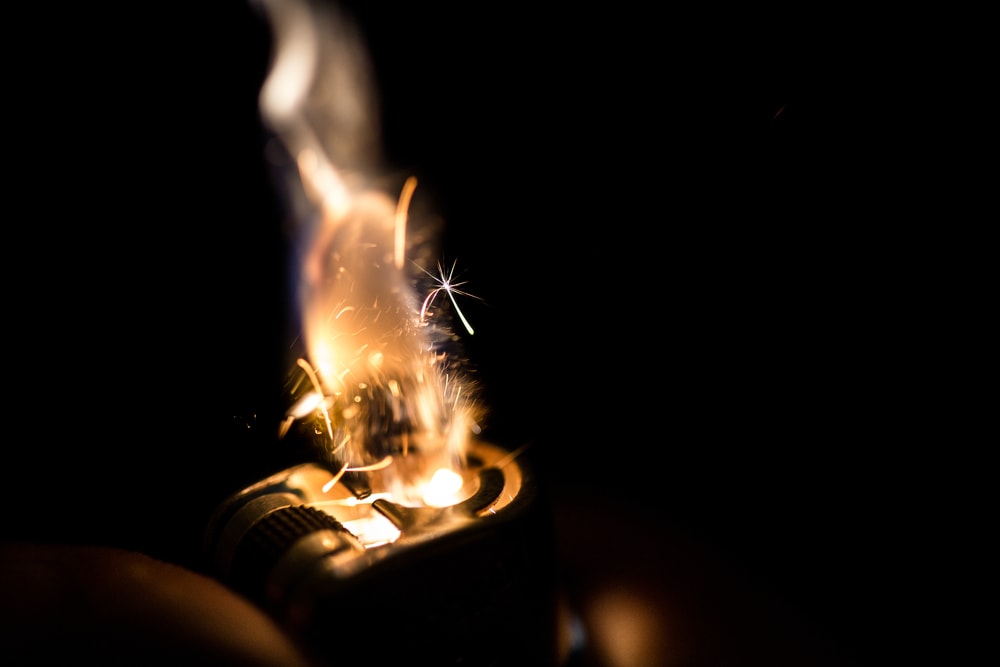 Close up photo of the spark in the lighter in the dark