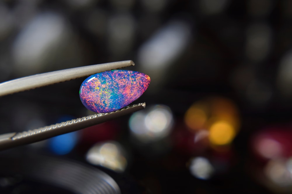 Opal held by on a tweezer