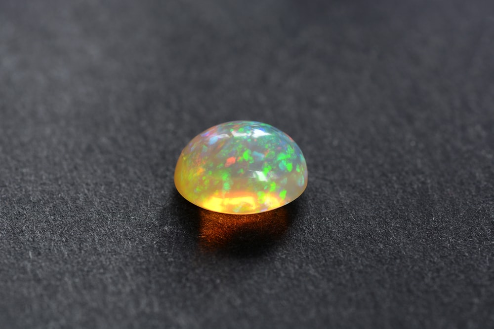 Ethiopian “Welo” Black Opals laying on black ground