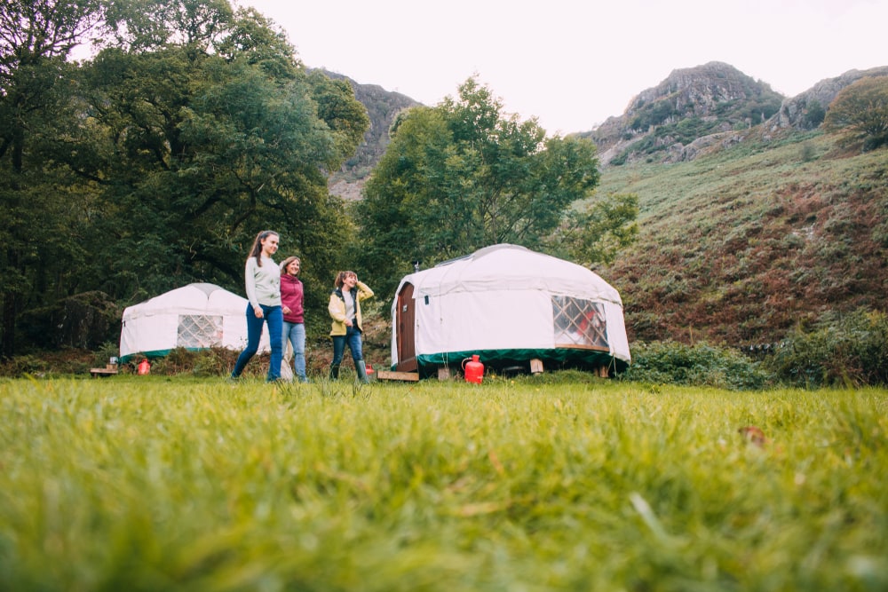 a family and a camping yurt in a campground