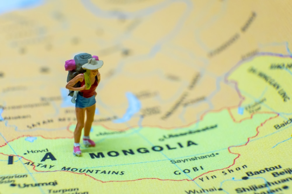 a camper figurine on Mongolia on a map