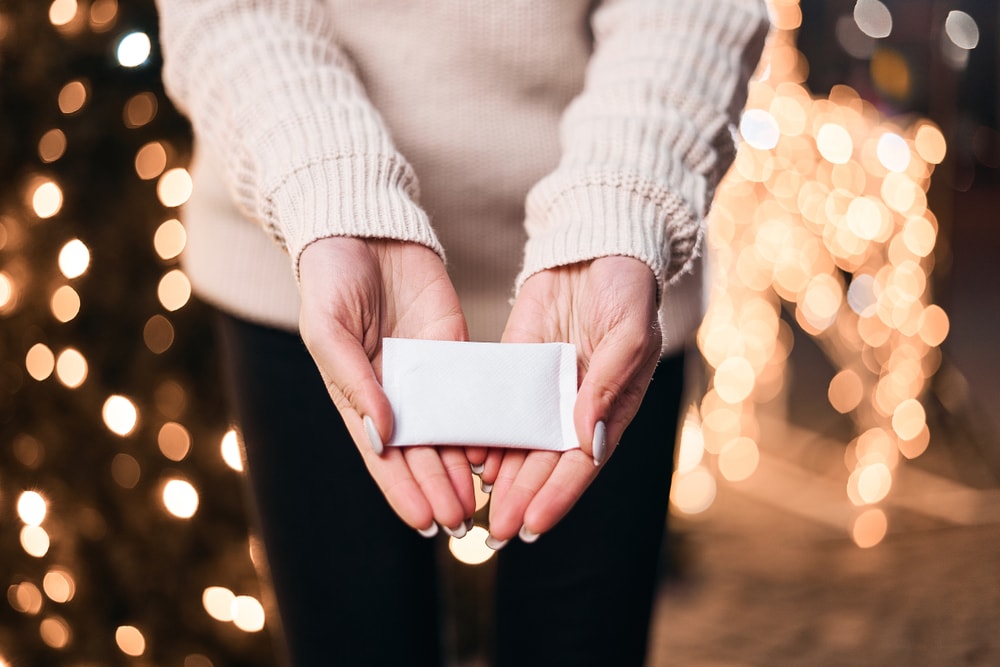 image of a woman holding a hand warmer 