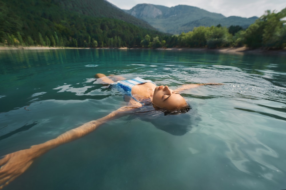a woman leisurely floating on the lake 