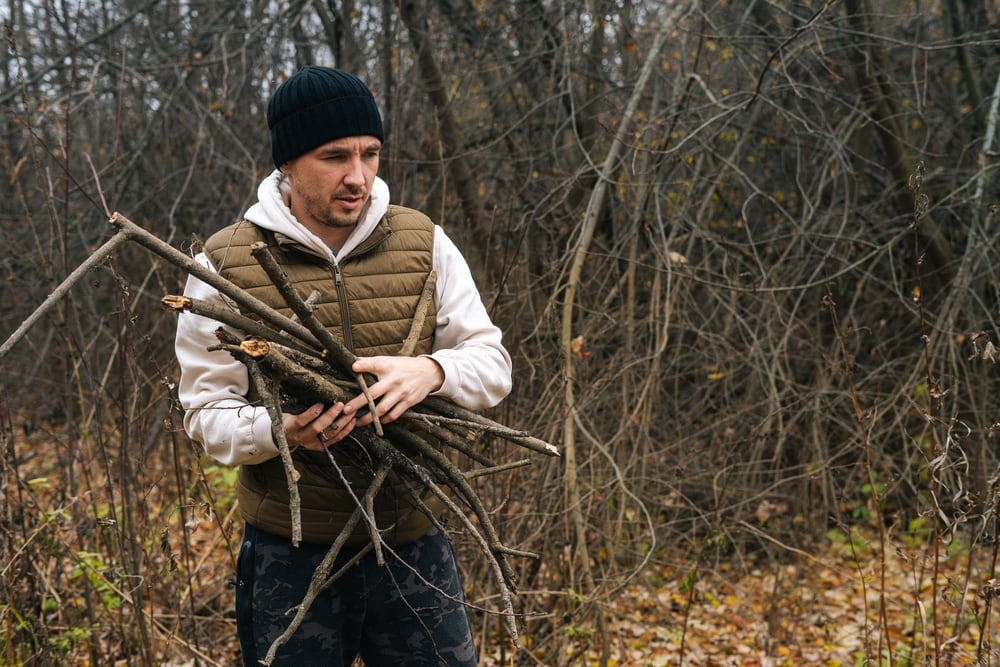 a man holding dry deadwoods