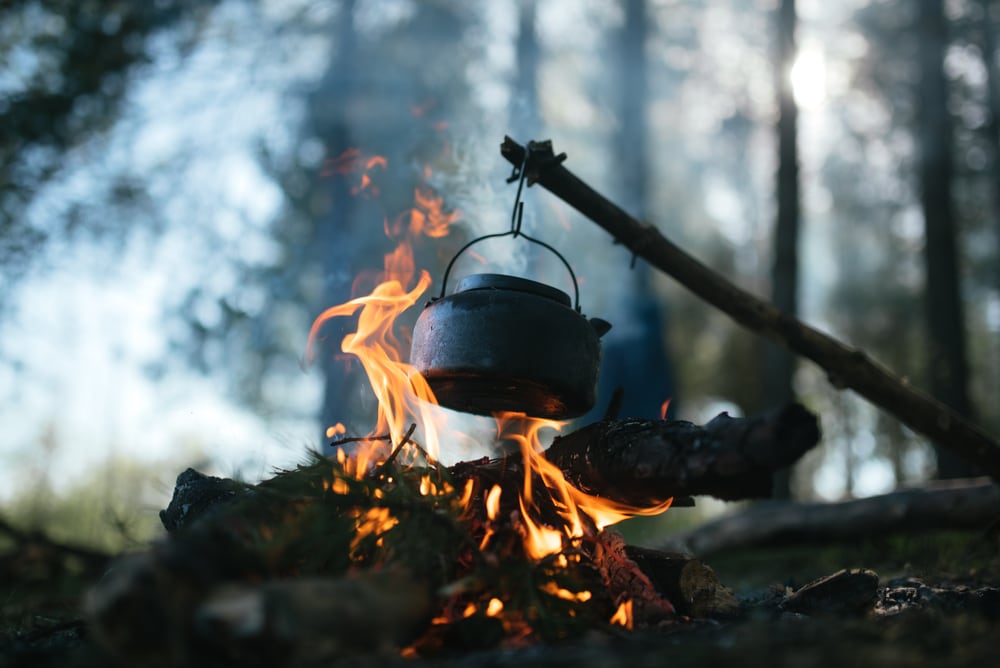Cooking in a pot over campfire