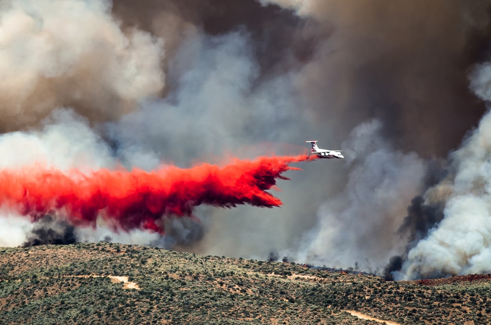 an aircraft dropping a fire retardant