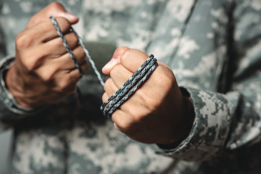 a soldier holding a paracord