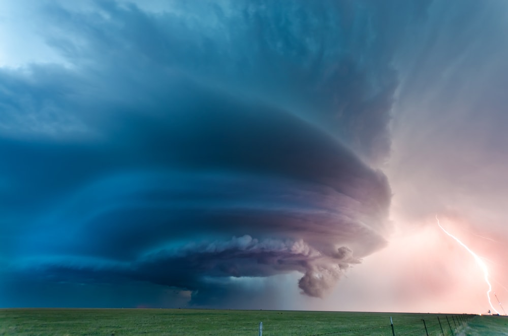 Tornado landing on the field with lightning on the side