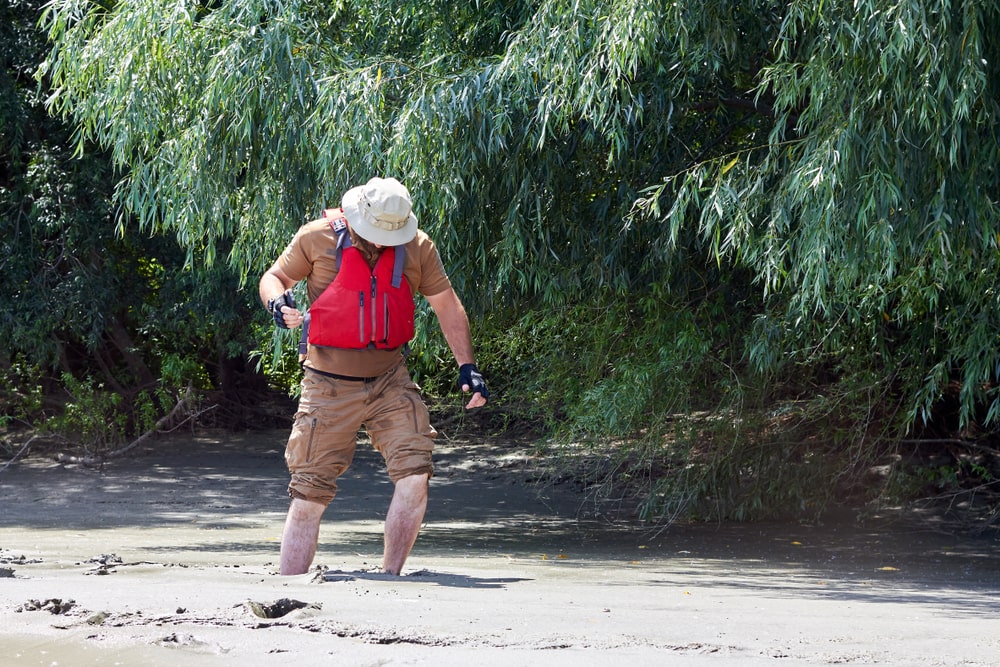 A man trying to get out of a quicksand