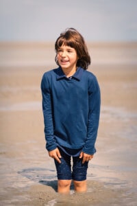 a young girl having fun with quicksand on the beach