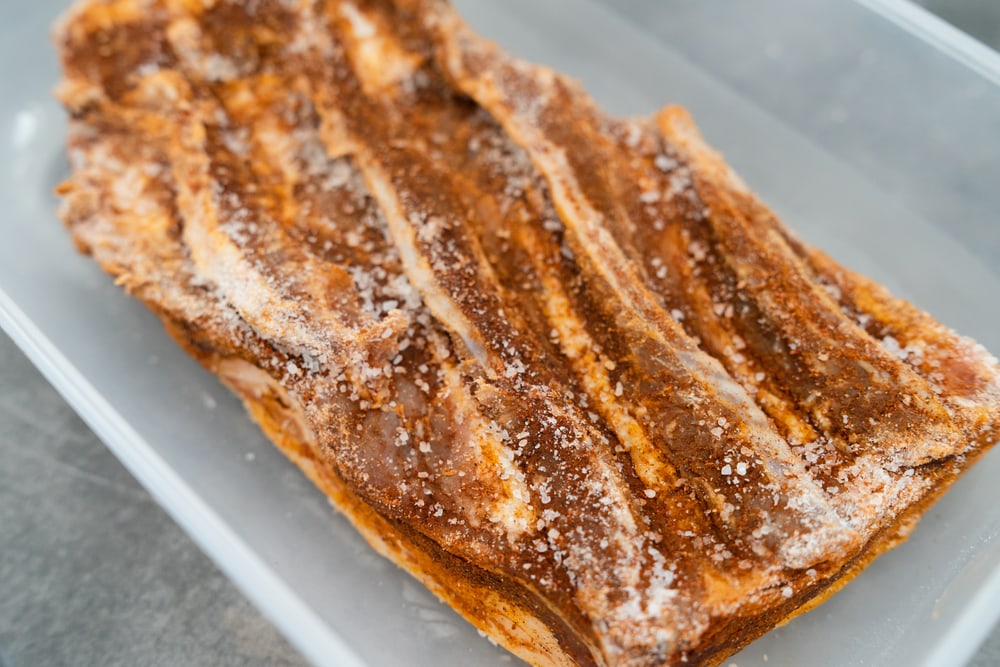 A home made bacon cured with salt or sodium nitrite