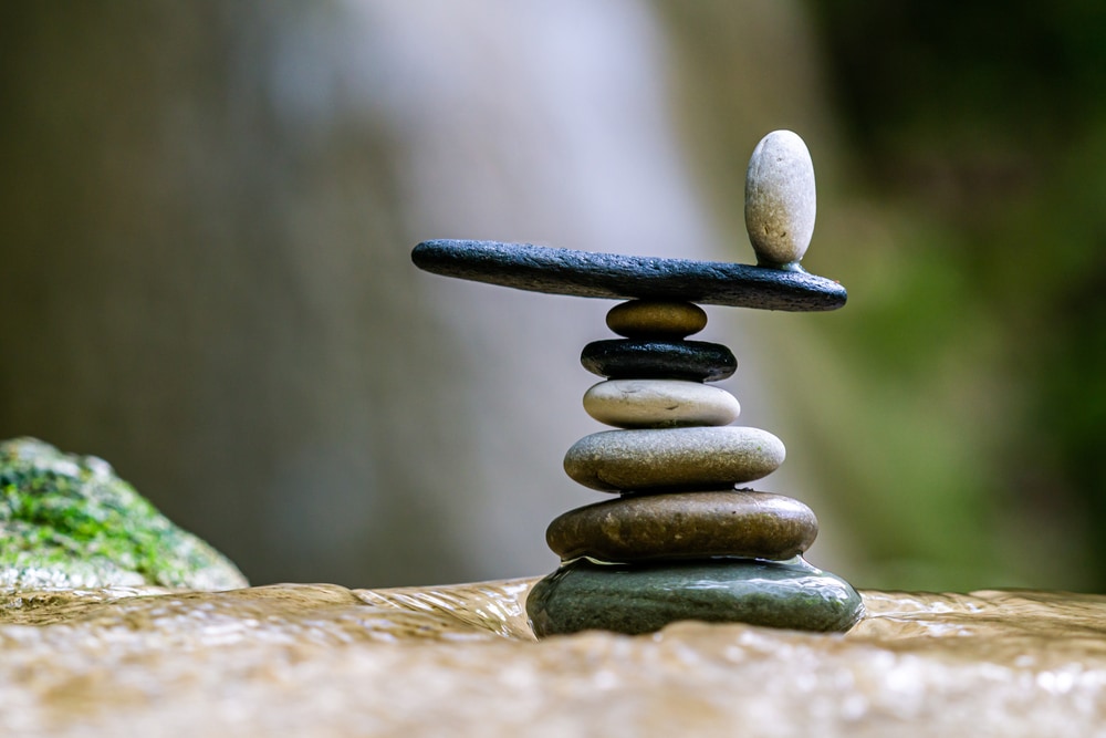Balanced stacked rocks by a waterfall